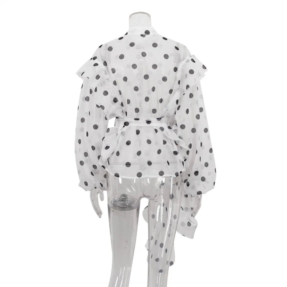 White outfit with black polka dots on a mannequin against a white background