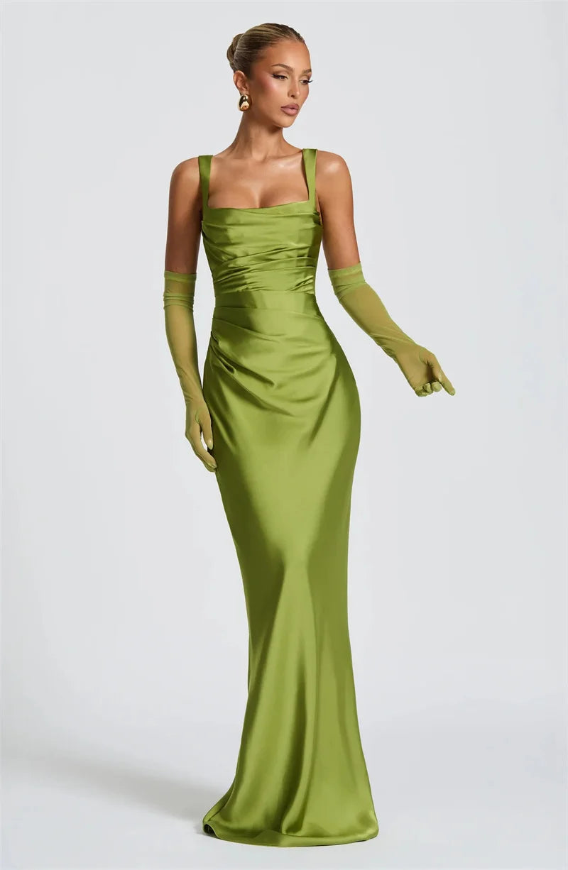 Woman wearing a green evening gown with matching gloves 