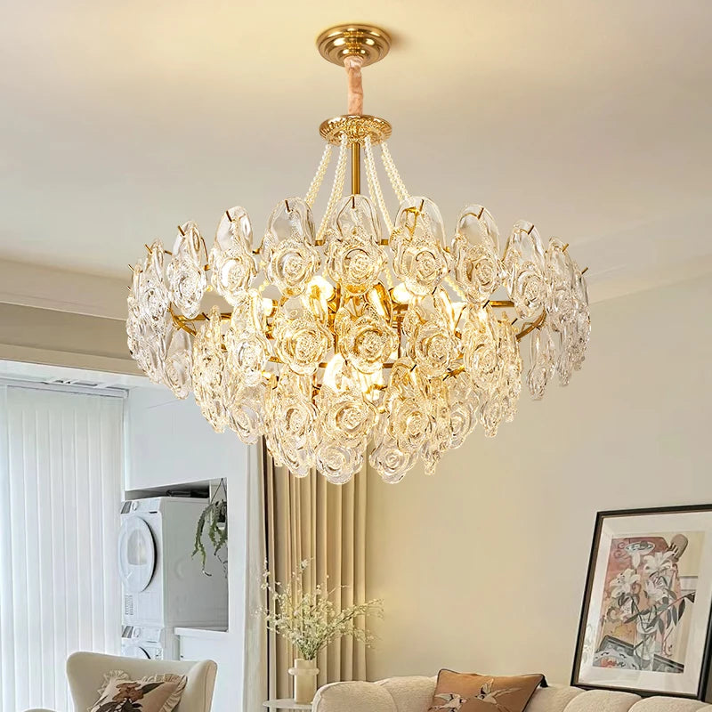 Luxurious rose pearl glass chandelier with white floral shades and gold accents hanging in a stylish living room