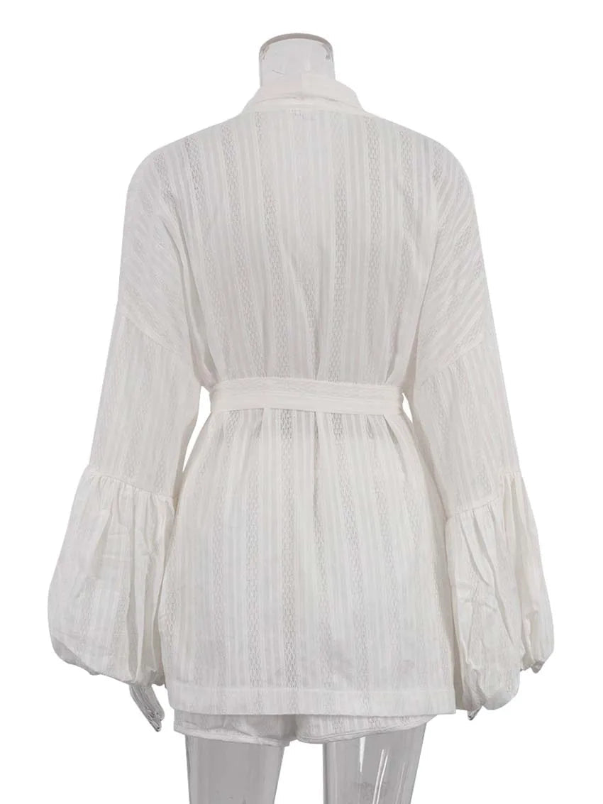 White pleated blouse on a mannequin with a white background