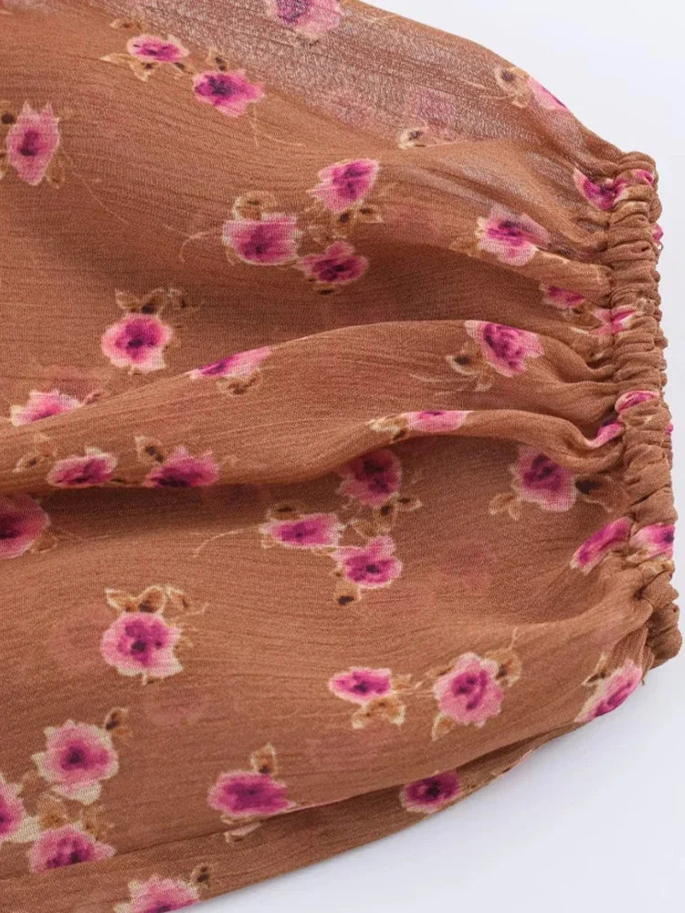 Brown fabric with pink floral patterns on a white background