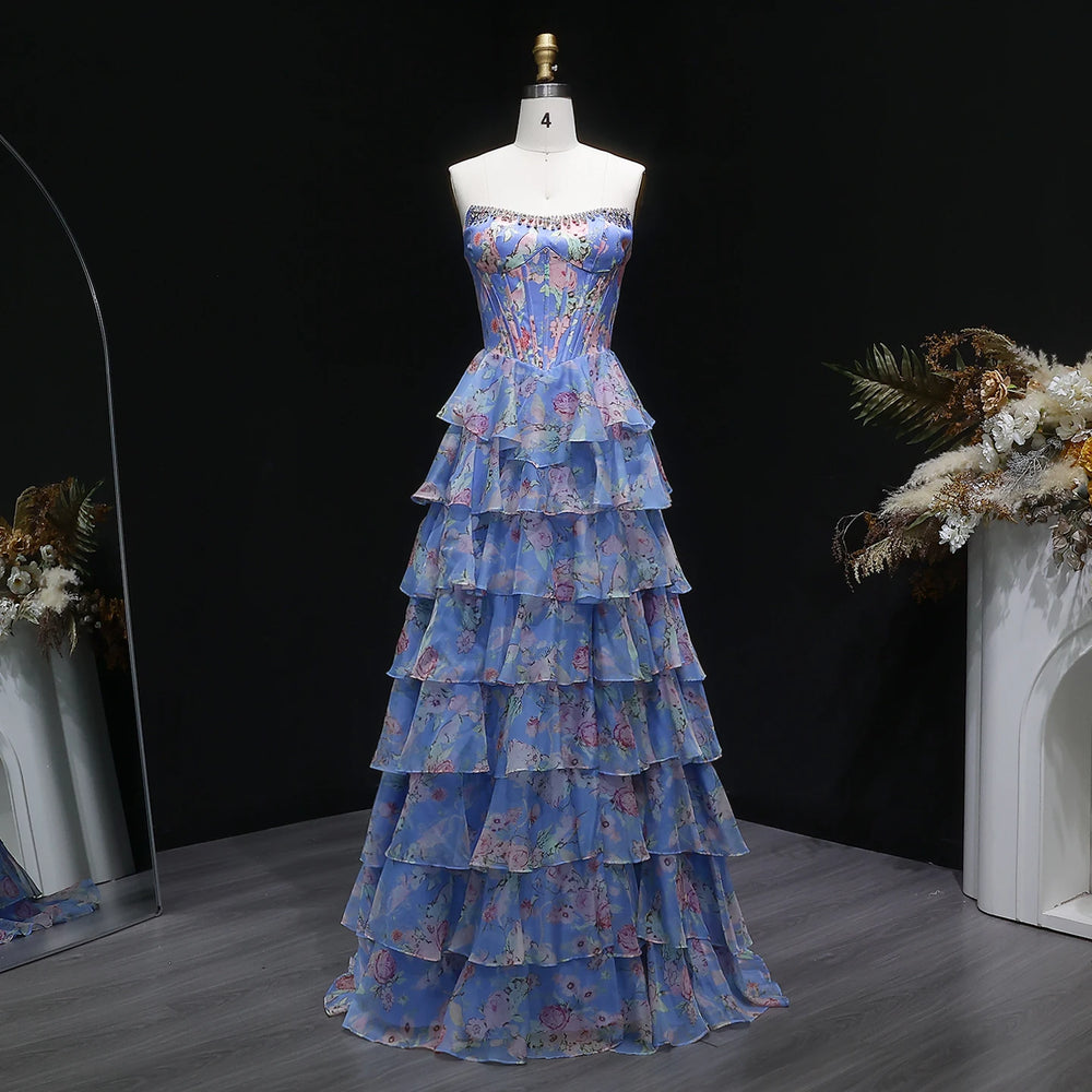 Blue floral tiered dress on a mannequin against a dark background