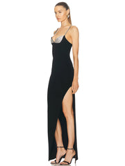 A model wearing a stunning black diamond spaghetti strap maxi dress with a backless design.