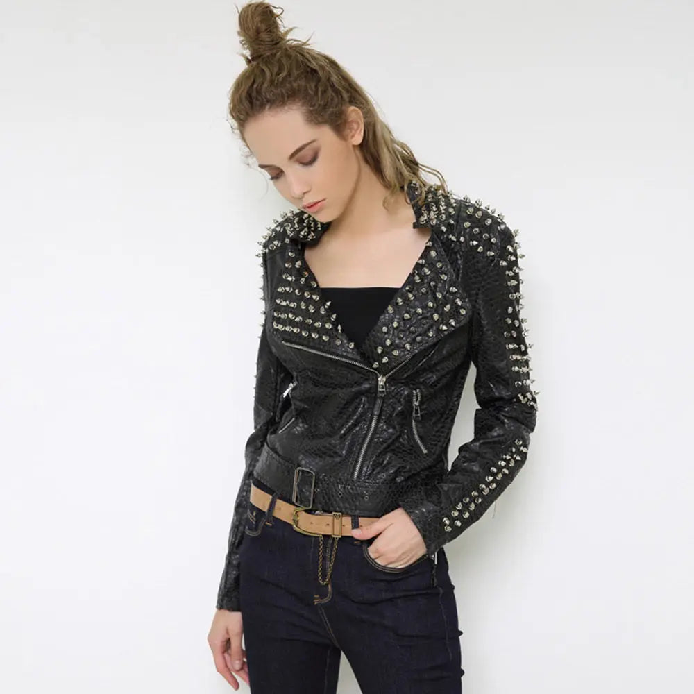 Woman wearing a black studded jacket against a white background