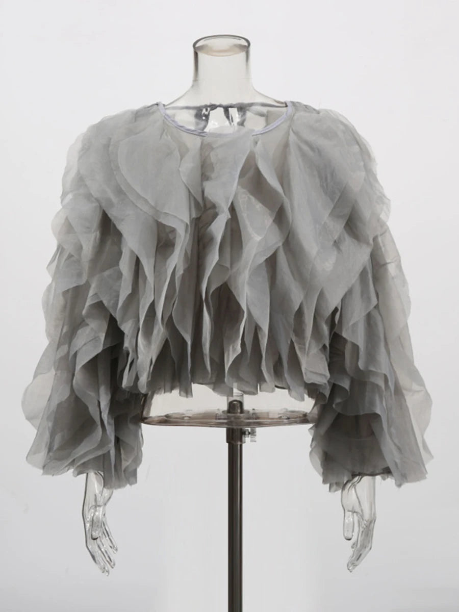 Gray ruffled garment on a mannequin against a white background