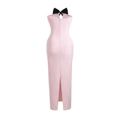 Pink dress with a black bow on a white background