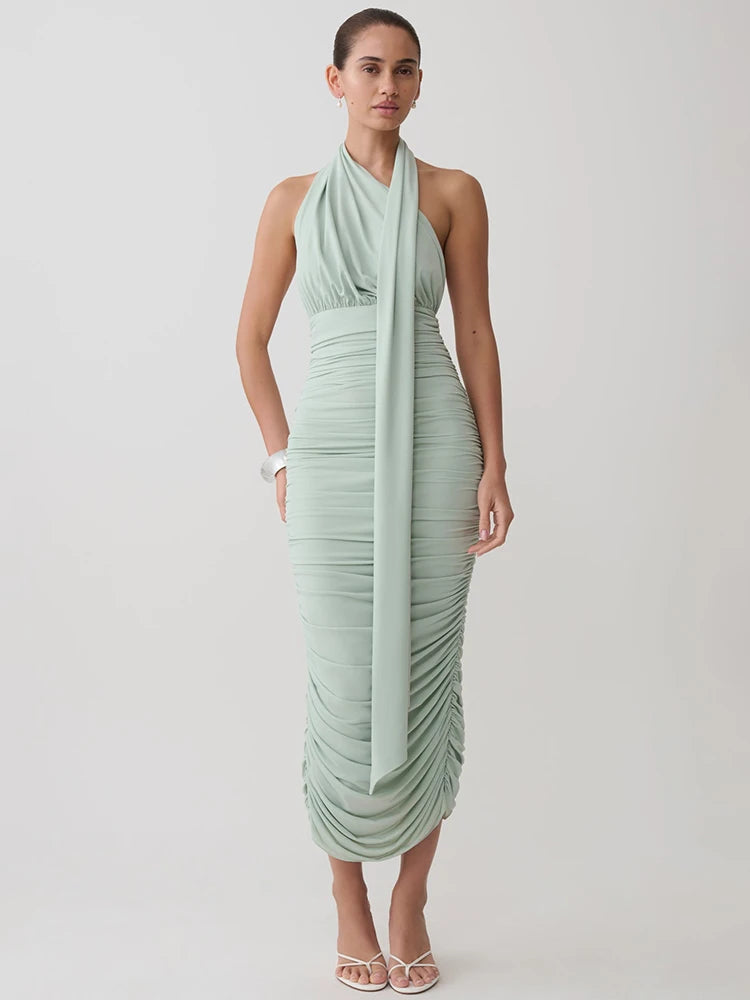 Back view of sage green halter neck ruched midi dress