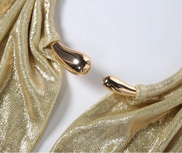 Gold hoop earrings with a textured gold fabric background