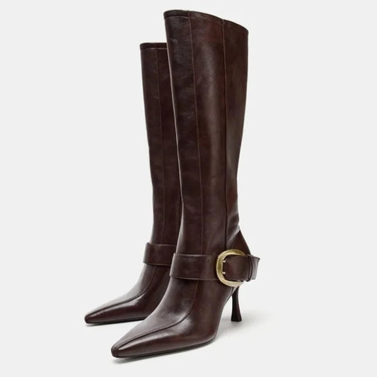 Pointed toe stiletto heel knee high boots with buckle detail.