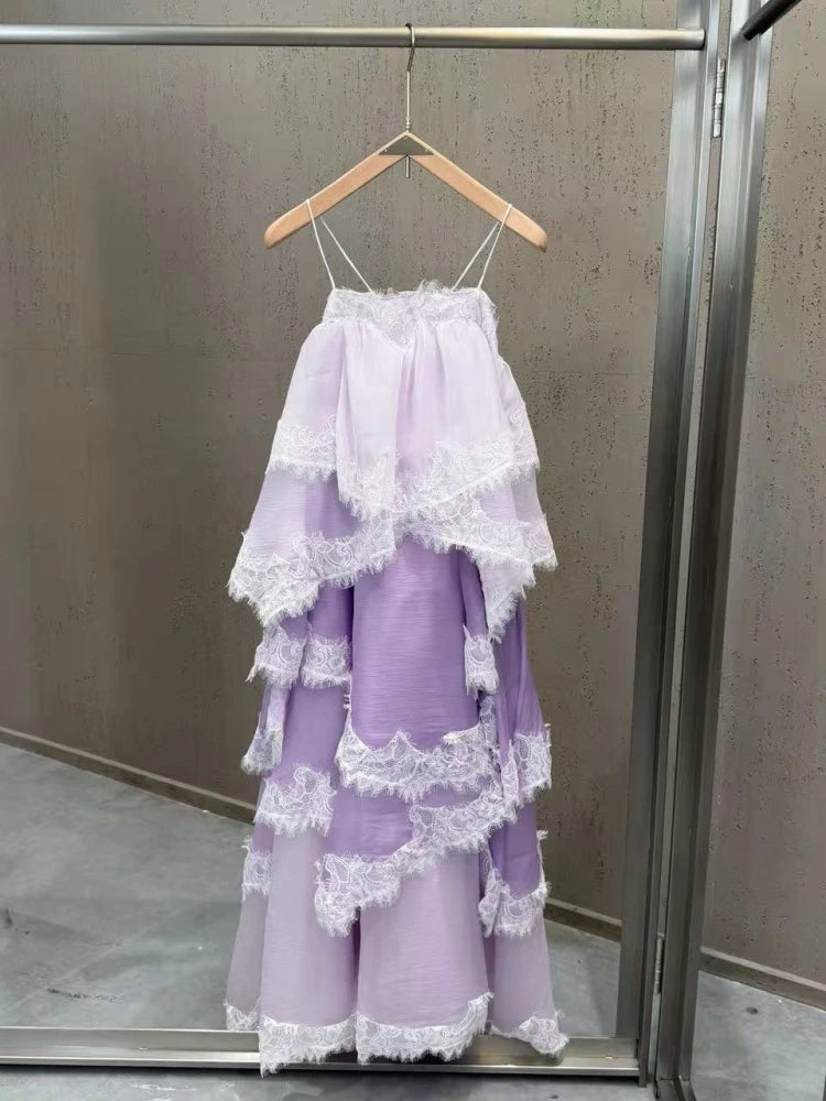 Lavender dress with lace details on a hanger against a neutral background
