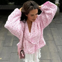 Floral quilted kimono jacket worn by a model outdoors, hands in hair