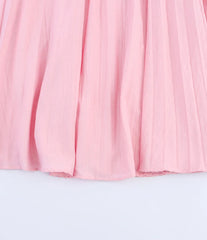 Pink pleated skirt on a light gray background