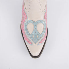 White shoe with pink and blue heart design on a light gray background