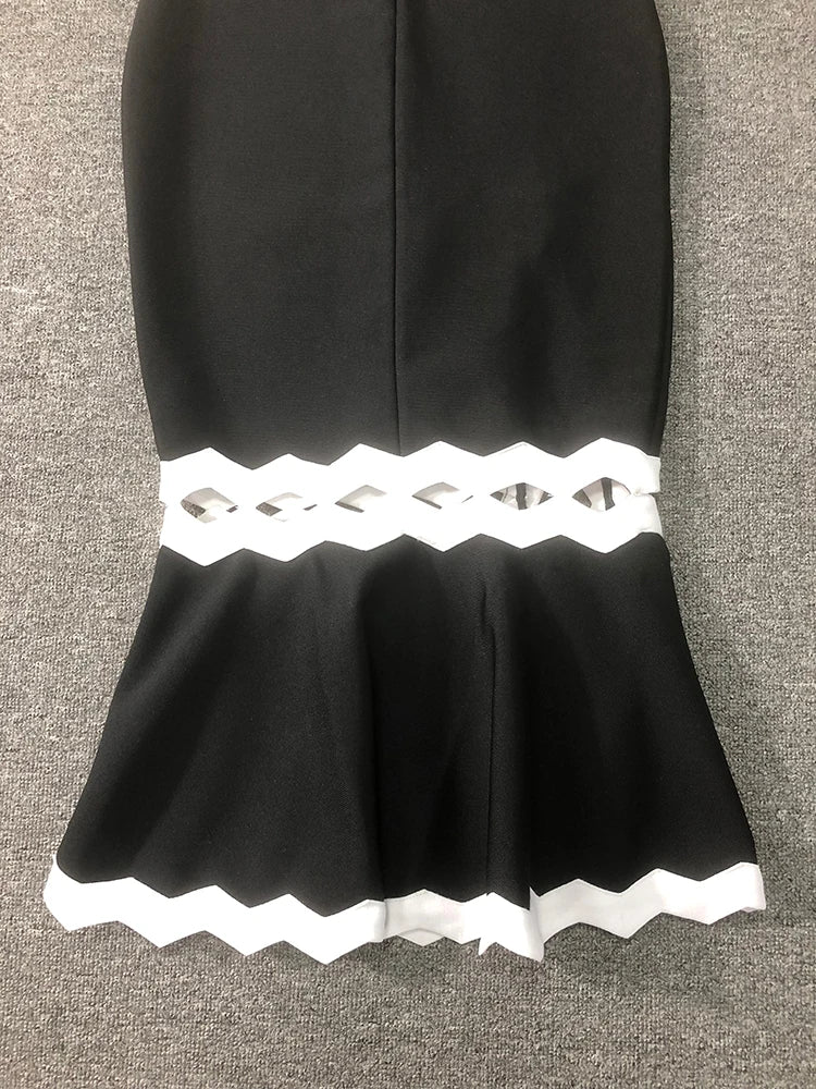 Black skirt with white lace trim on a gray background