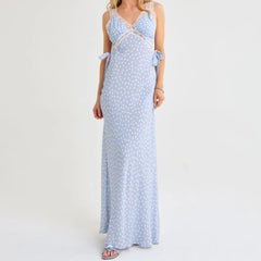 Woman wearing a light blue polka dot dress on a white background