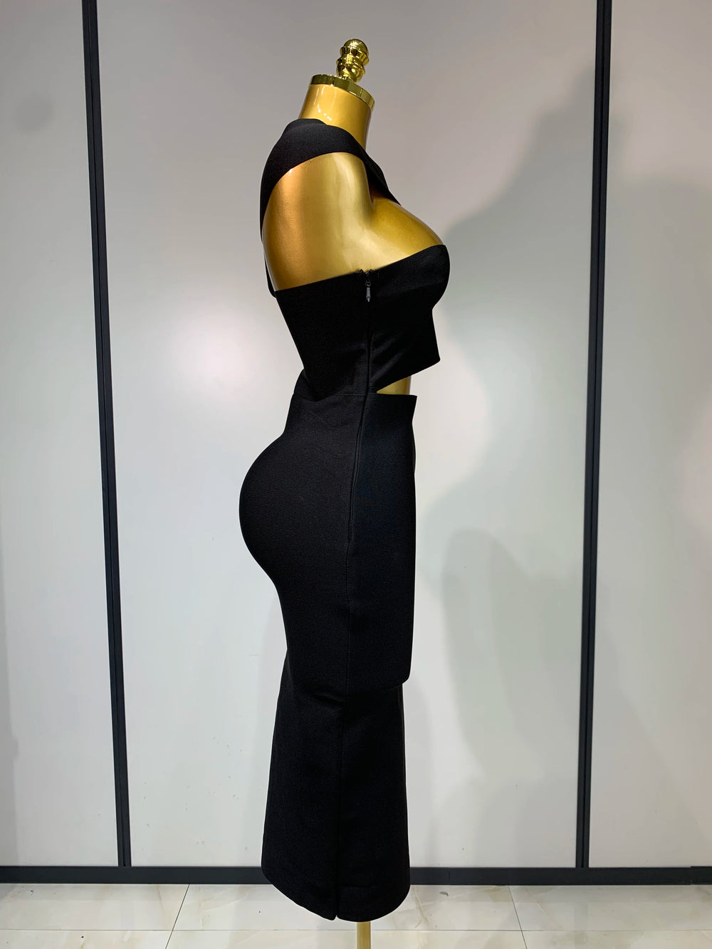 Black strapless sheath midi dress with hollow out detail.