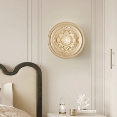 A round Art Deco wall sconce with a milk white glass shade, casting a warm glow C