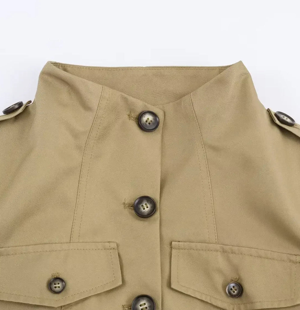 Close-up of a beige jacket with button details on a white background