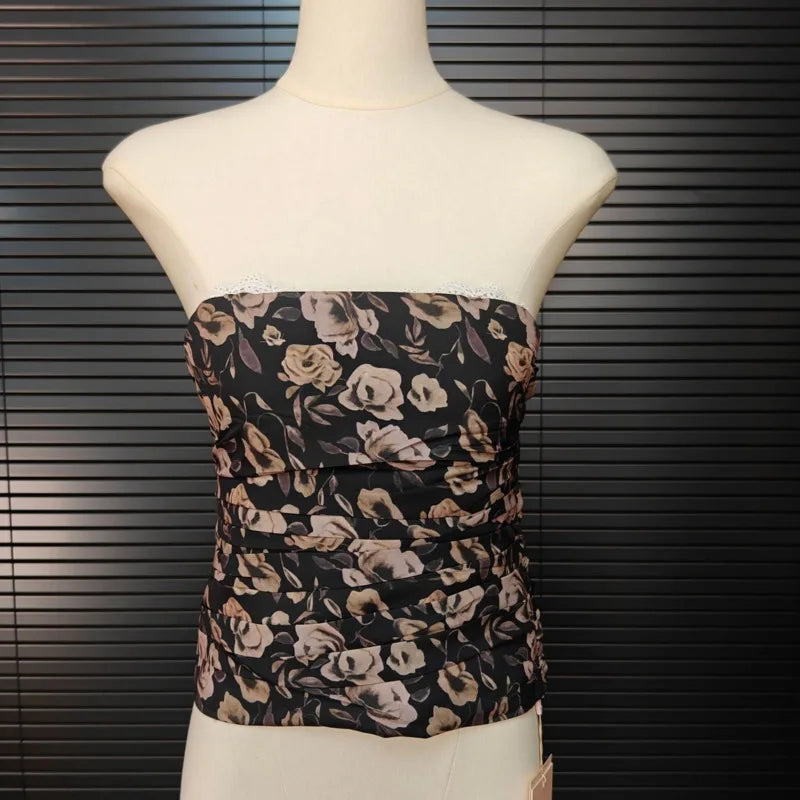 Floral strapless top on a mannequin against a dark background