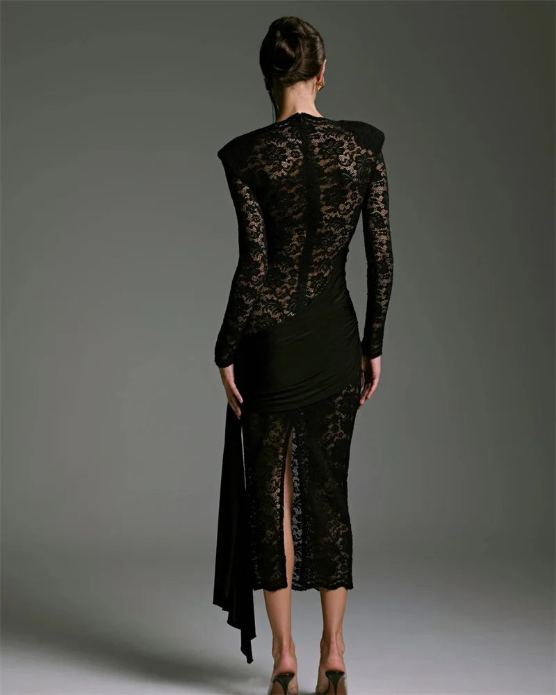 Black lace dress on a model against a gray background