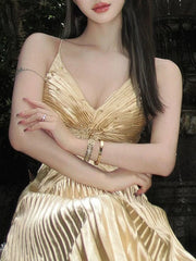 Woman wearing a Sling Pleated Golden Floor-Length Dress from Golden Atelier, showcasing the full length and elegant silhouette.