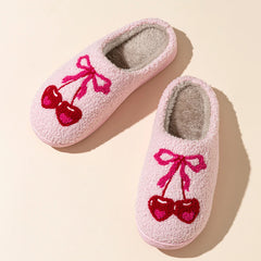 Top view of pink plush slippers with cherry bow embroidery
