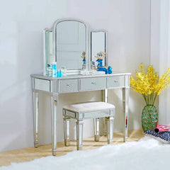 Silver vanity table with mirror and stool in a room setting.