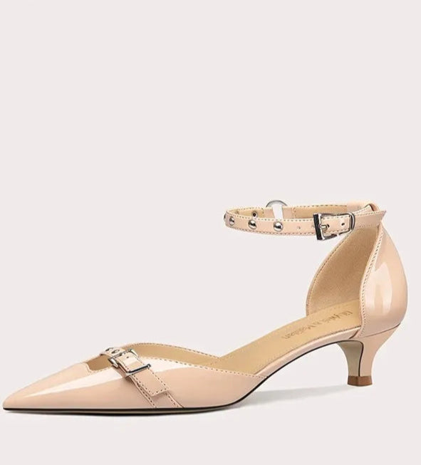 Beige high-heeled shoe on a light gray background