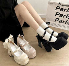 Lolita platform heels with bow detail and striped socks for Kawaii fashion look