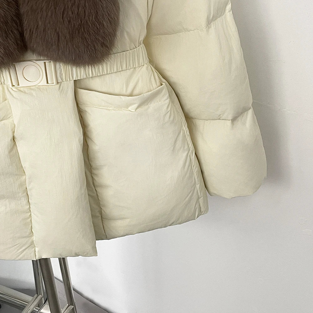 Beige puffer jacket with fur trim on a mannequin against a white background