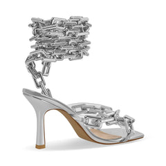 Side view of silver chain ankle-wrap stiletto sandals