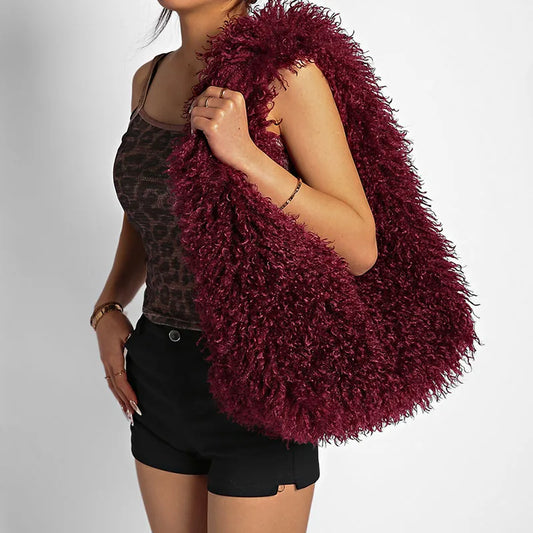 Burgundy faux fur textured shoulder bag worn by a model.