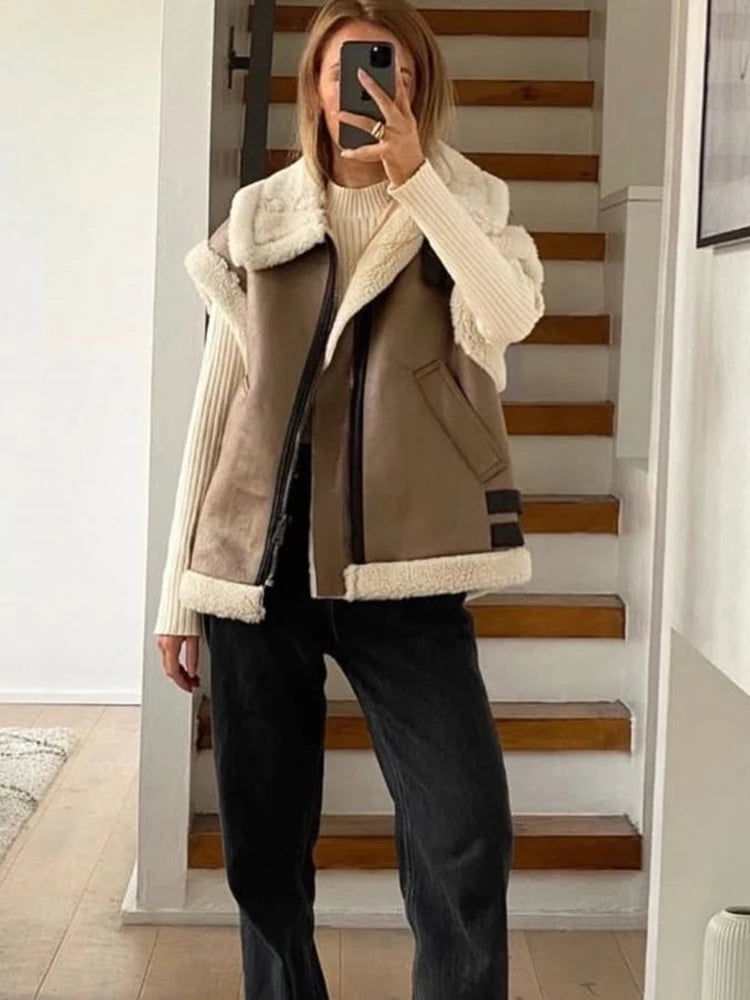 Person wearing a brown vest with white fur trim in a home setting.