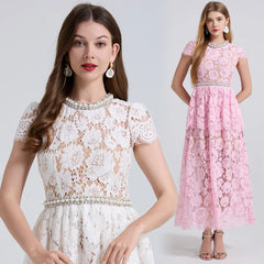Two women wearing lace dresses, one white and one pink, on a plain background.