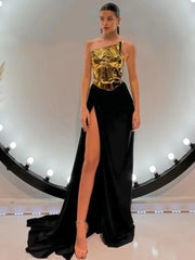 A model wearing a glamorous strapless gold top and high-slit black skirt set, perfect for evening events. Golden Atelier 2