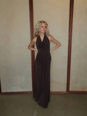 Brown halter neck draped maxi dress against a neutral background