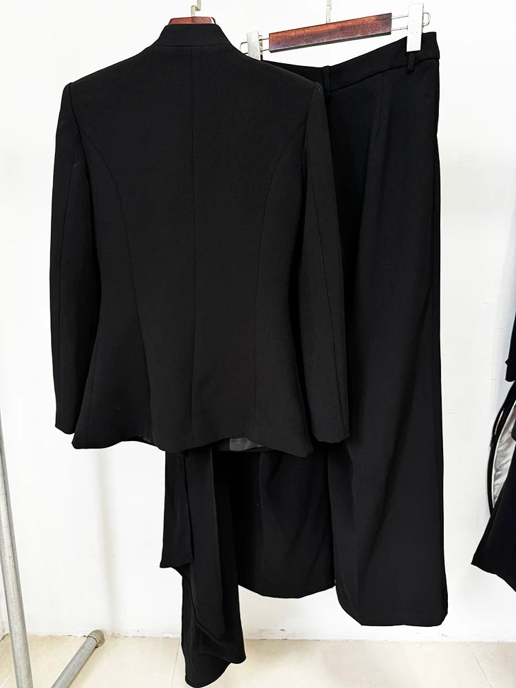 Back view of black pleated draped blazer and wide leg pants suit on hanger