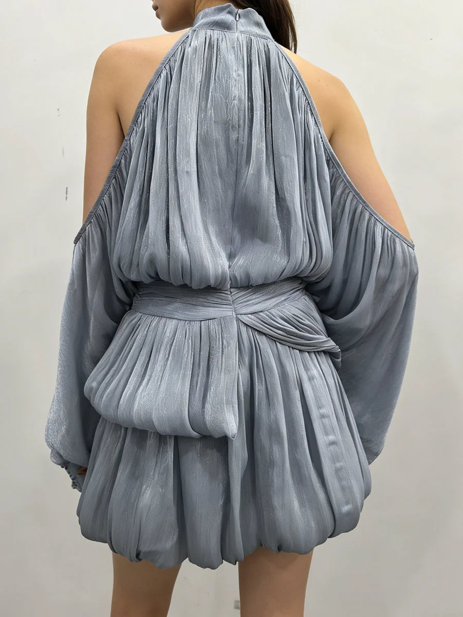 Blue pleated dress with a halter neck and wide sleeves on a plain background