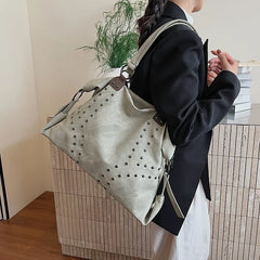 Green studded PU leather shoulder bag on a person