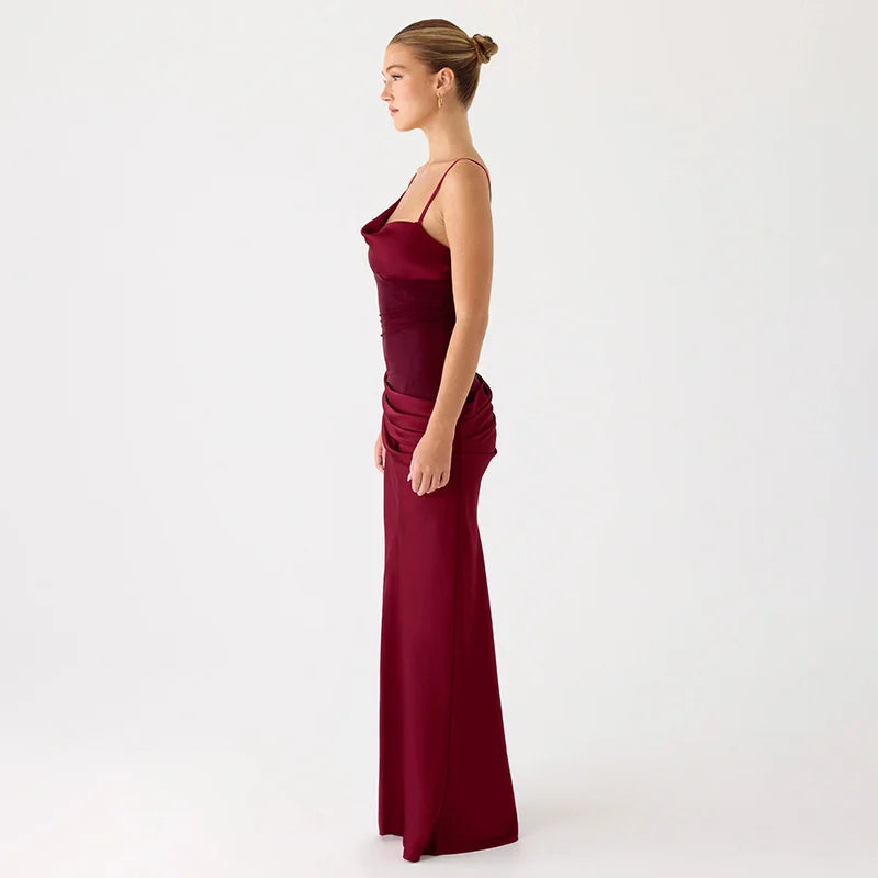 Woman wearing a burgundy evening gown on a white background