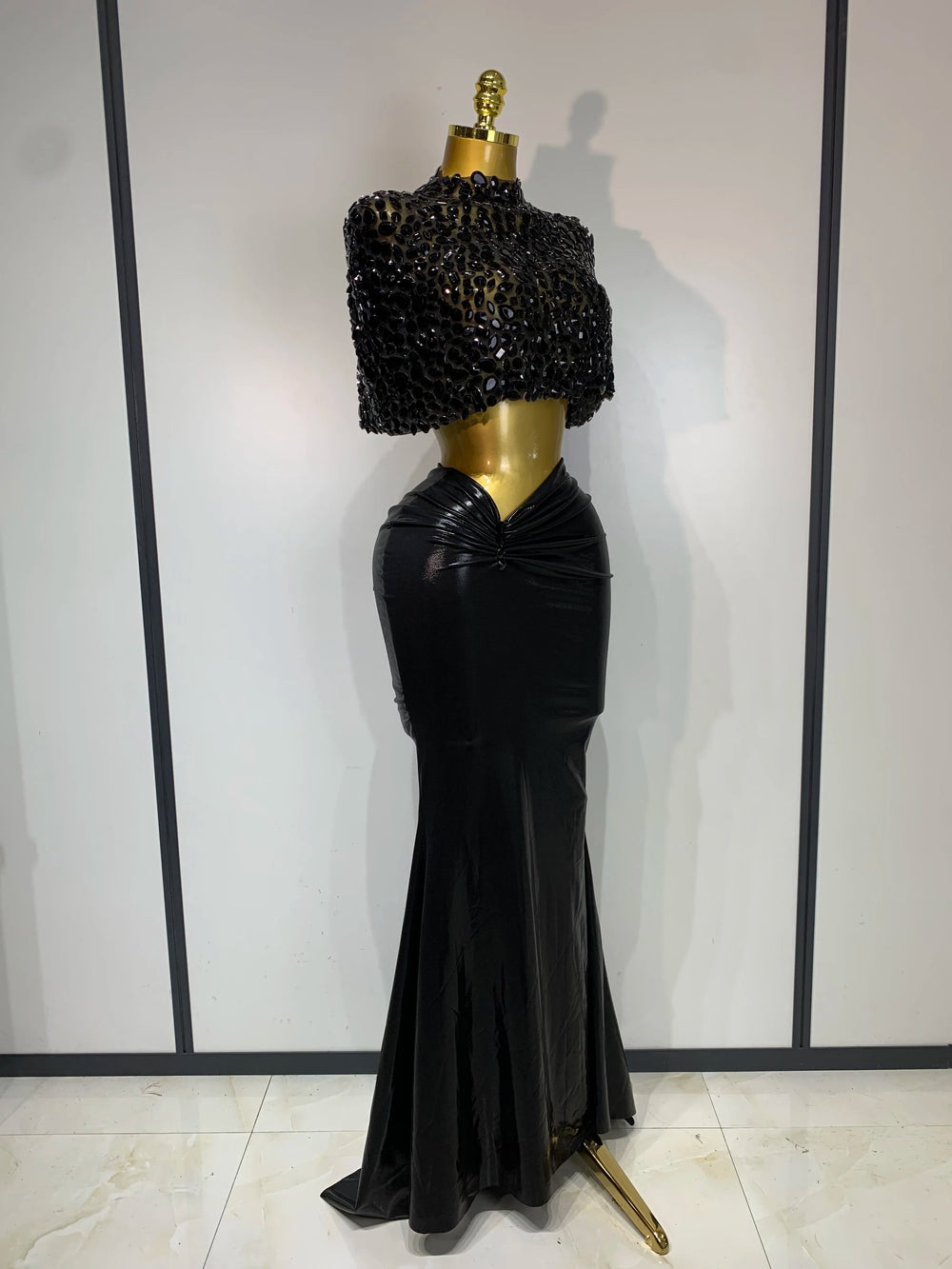 Black embellished mock neck sleeveless top and draped faux leather maxi skirt set