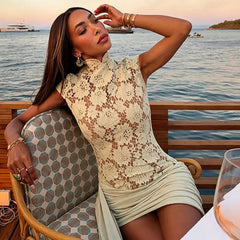 Model wearing a green lace mock neck short sleeve dress