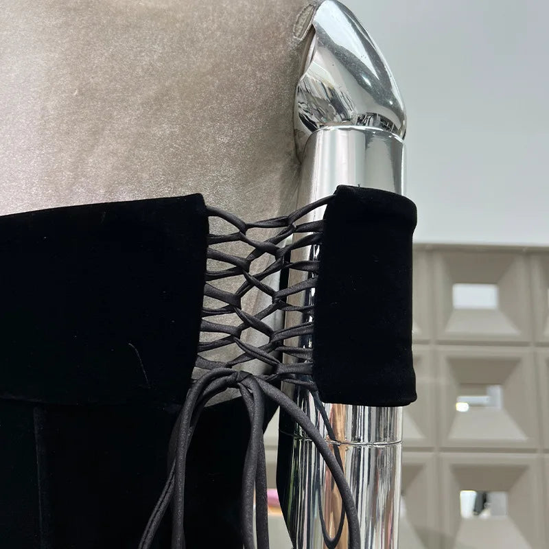Close-up of a chair arm with black lace detailing and a metallic finish.