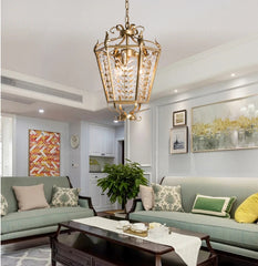 Modern living room with a chandelier, couches, and coffee table.