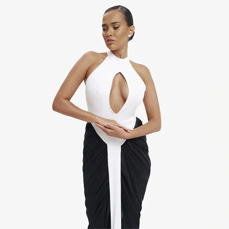 Woman wearing a white halter top and black pants on a white background