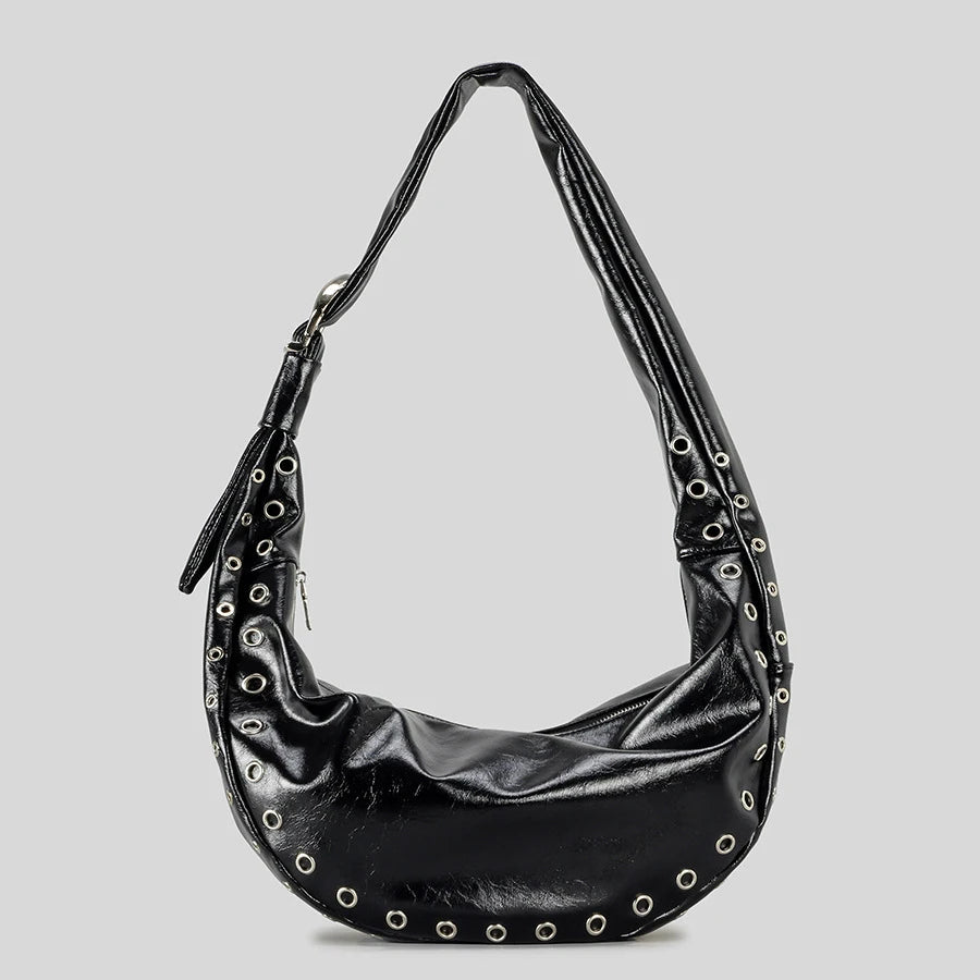 Black handbag with studded details on a light gray background