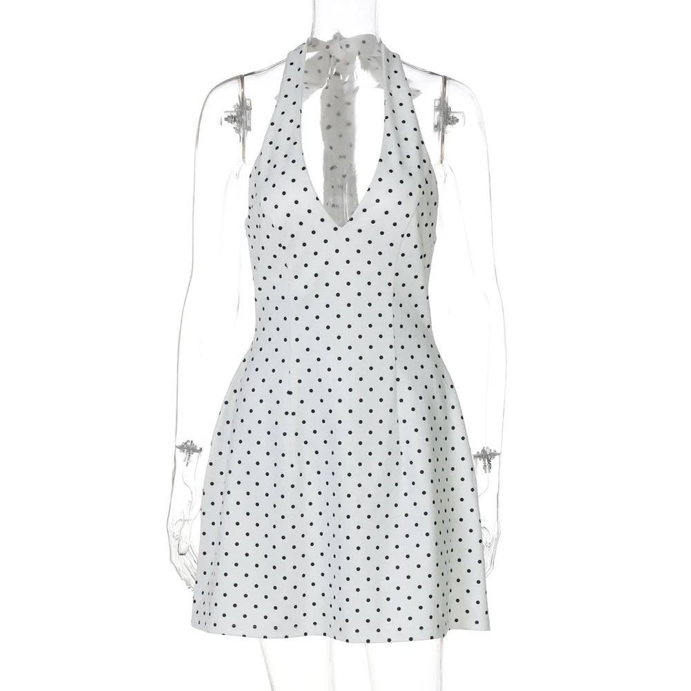White dress with black polka dots on a mannequin against a white background