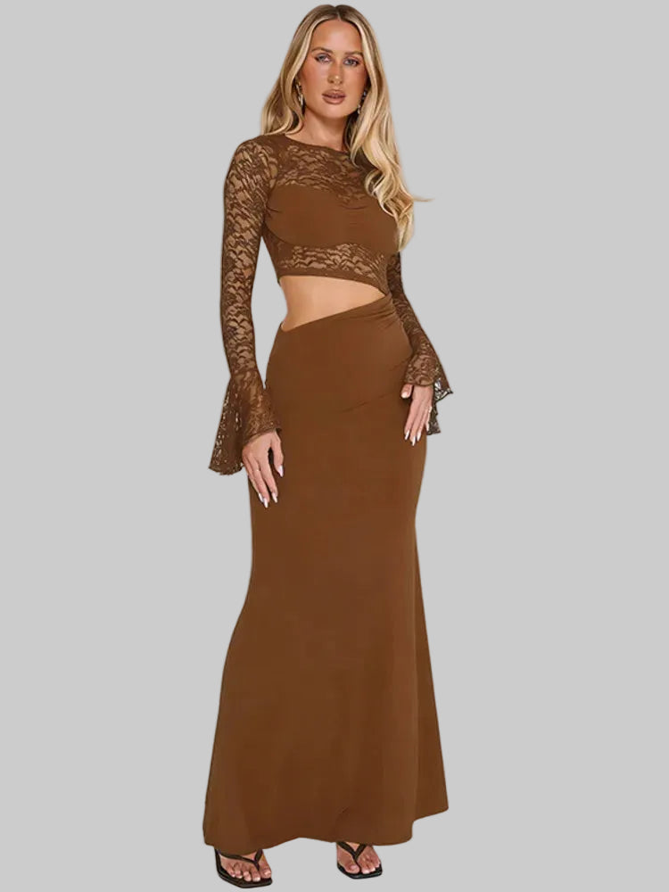 Woman wearing a brown dress with lace sleeves on a gray background