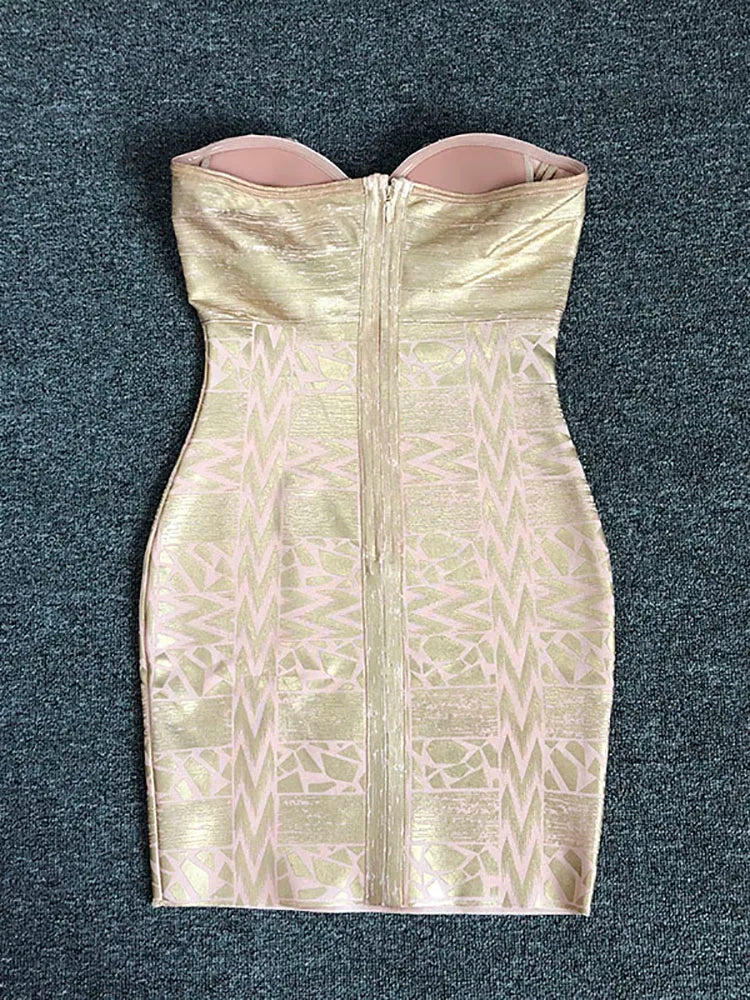 Gold strapless dress with geometric pattern on a dark gray background