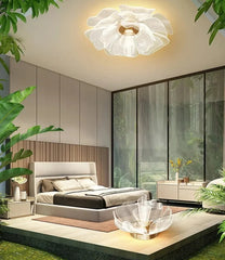 Modern bedroom with a ceiling light fixture, bed, and large windows.